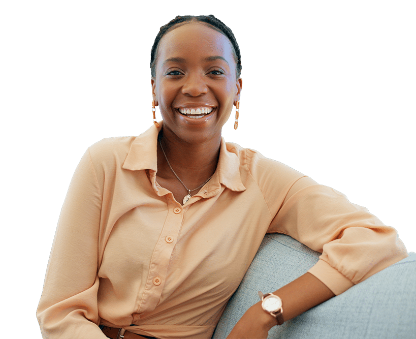 smiling woman sitting on couch with orange blouse