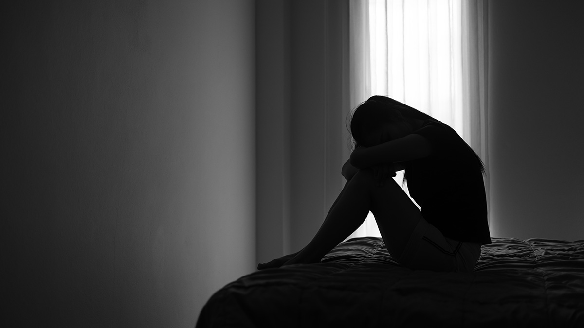 sad woman dealing with GPPPD on bed